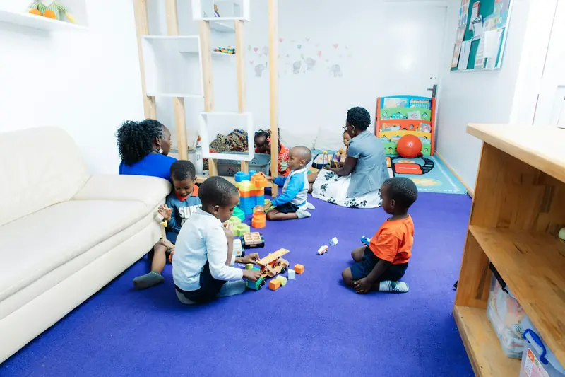 Children and an educator playing in a bright classroom