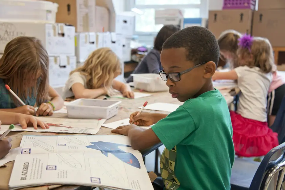 Children working on projects at a classroom table
